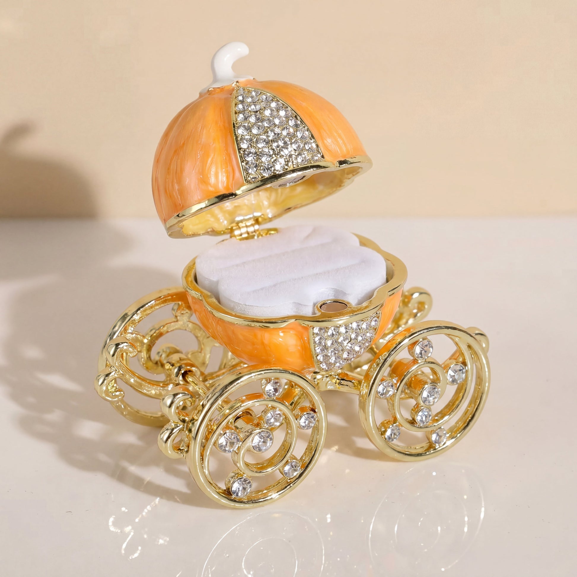 Orange pumpkin carriage jewellery box with removable white ring holder, designed for storing rings and small jewellery pieces.
