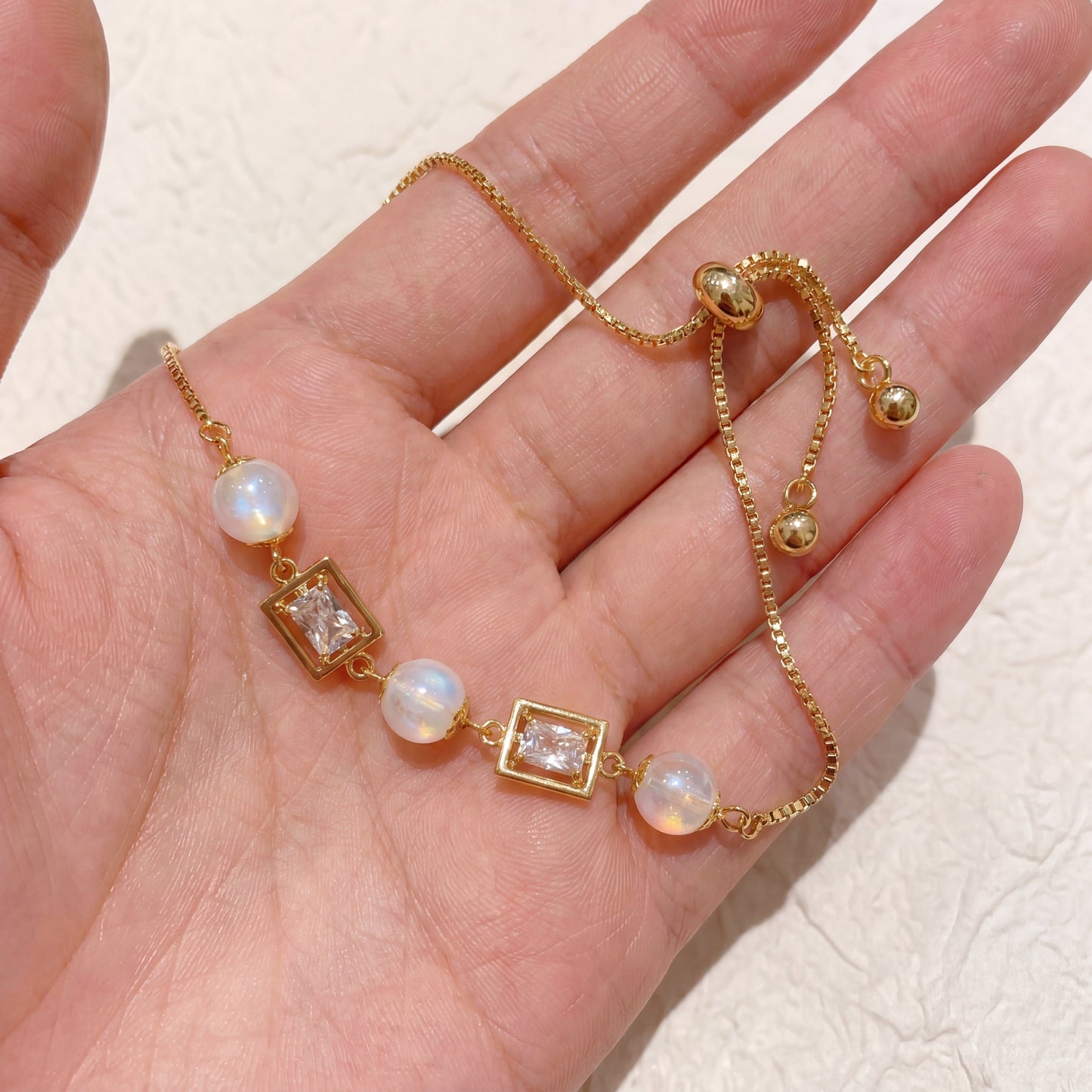 Vintage pearl square cubic zirconia gold bracelet shown in hand for size and detail