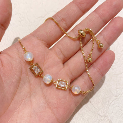 Vintage pearl square cubic zirconia gold bracelet shown in hand for size and detail