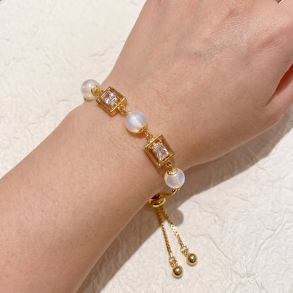 Vintage pearl square cubic zirconia gold bracelet worn on wrist with elegant adjustable chain