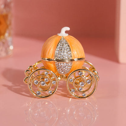 Vintage orange pumpkin carriage jewellery box with gold carriage wheels and sparkling crystal-style details.
