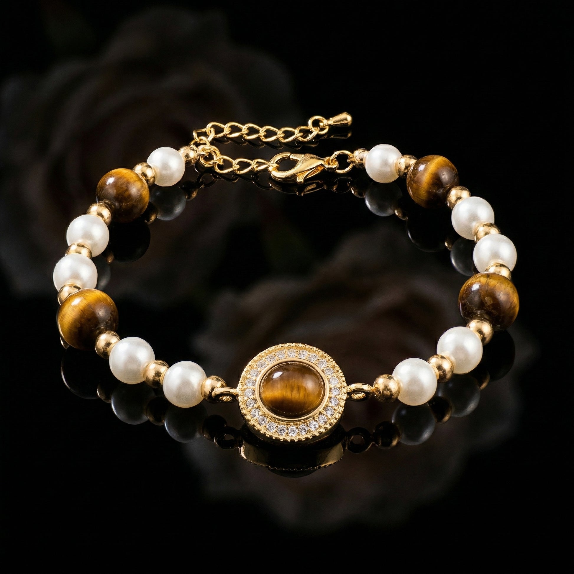 Vintage Tiger’s Eye & Pearl Gold Tone Bracelet with oval tiger’s eye centrepiece, pearl bead accents and gold tone chain on black background