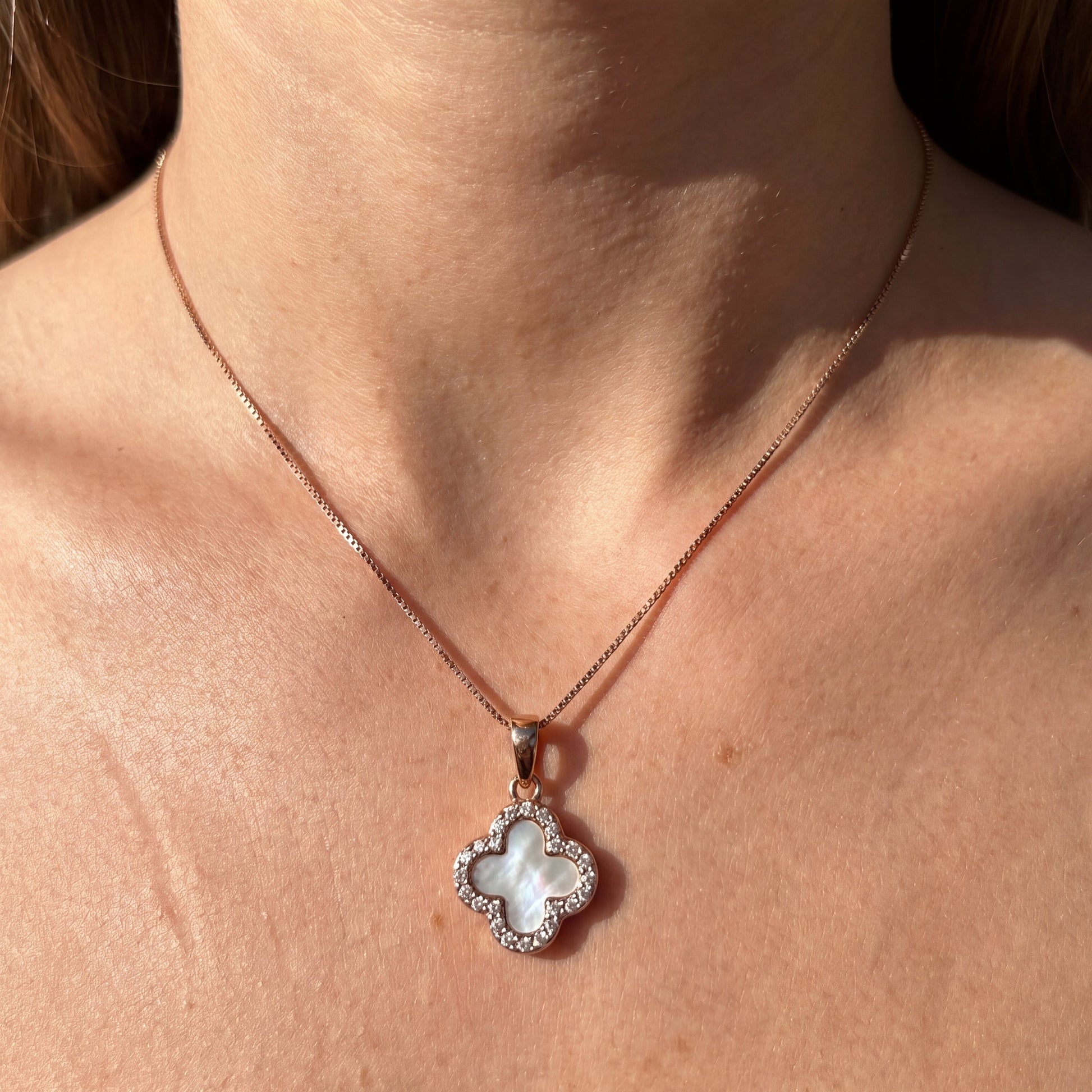 white four leaf clover pendant necklace with rose gold chain worn by model