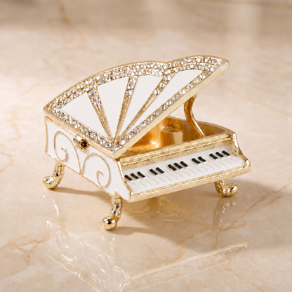 Open white grand piano jewellery box showing gold jewellery storage compartment